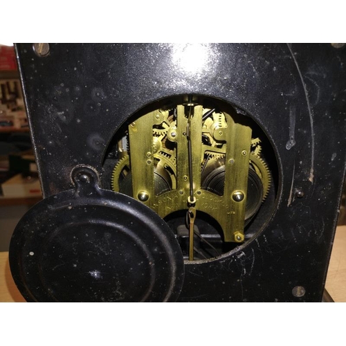 2181 - A Victorian black enamelled cast iron Mantle clock. 24cm x 12cm x Height 26cm. Springs ok but wound ... 