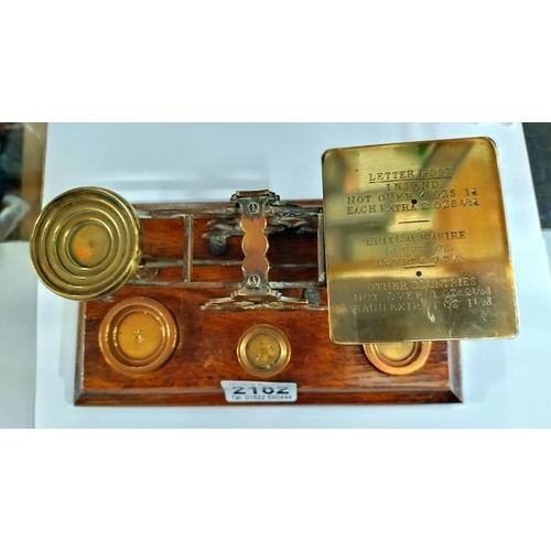 2182 - Victorian/Edwardian brass postal scales by S. Morden & co London. On a Oak base with weights