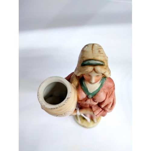 2193 - A Royal Dux figure of a woman with urn. 21cm. Chips to sleeve of the dress