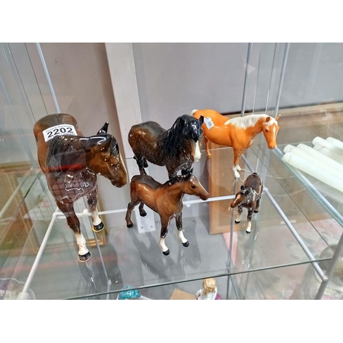 2202 - A quantity of Beswick horse figures. Four have minor chips to ears and the larger one has a mark to ... 