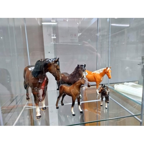 2202 - A quantity of Beswick horse figures. Four have minor chips to ears and the larger one has a mark to ... 