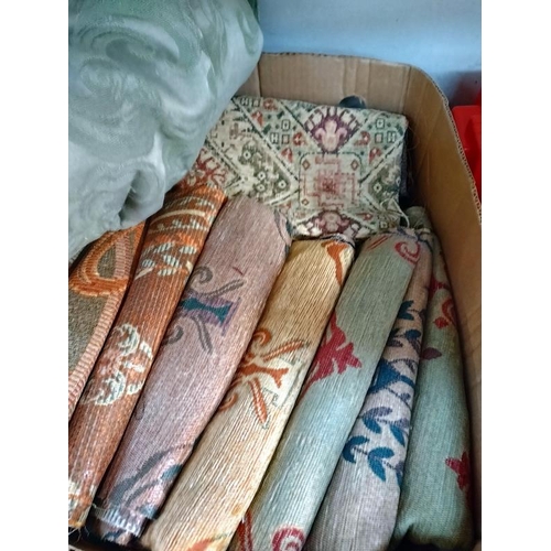 1055 - A box of fabric samples, woven textiles designs and a sage green large bedspread