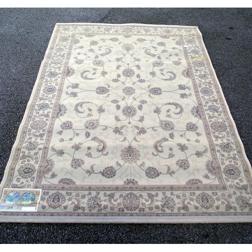 245 - A large beige patterned/ Persian rug. Length 2.28cm x 1.60cm, COLLECT ONLY.