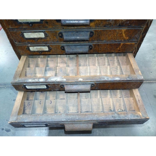 268 - A seven drawer printers cabinet set on brass wheels. 56cm x 45cm x 57cm.  COLLECT ONLY.