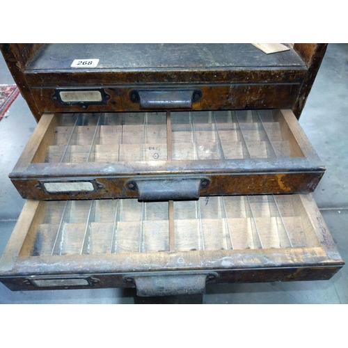 268 - A seven drawer printers cabinet set on brass wheels. 56cm x 45cm x 57cm.  COLLECT ONLY.