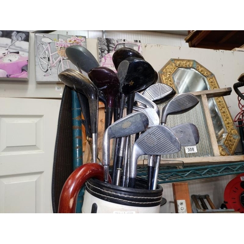 309 - A Golf bag, with a selection of Golf clubs and an umbrella.  COLLECT ONLY.