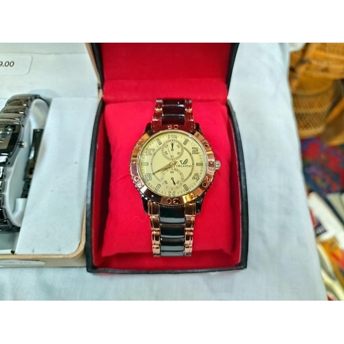 1121 - A boxed Swiss line wrist watch and Orlando watch.