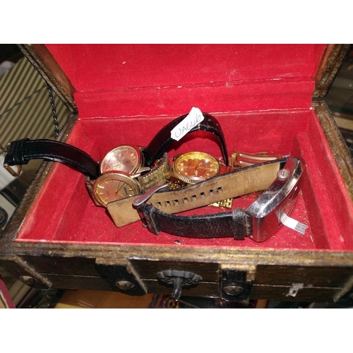 1166 - A quantity of wristwatches in a wooden trunk jewellery box.