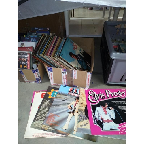 1299 - A quantity of Elvis LP's and VHS tapes. COLLECT ONLY.