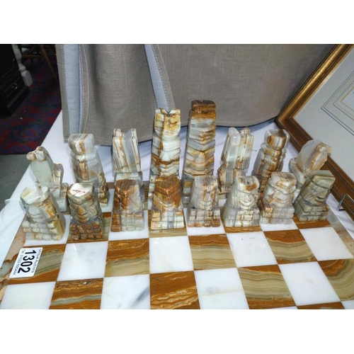 1302 - A polished stone chess set.  COLLECT ONLY.