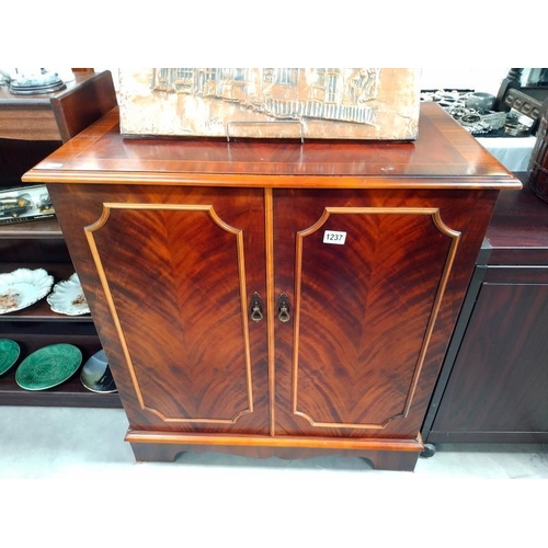 1237 - A dark wood stained 2 door cupboard with inner draw. 79cm x 47cm x height 88cm.  COLLECT ONLY.