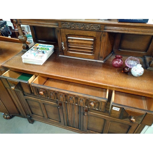 1279 - A 1950's oak buffet cupboard. 124cm x 48cm x 123cm.  COLLECT ONLY.