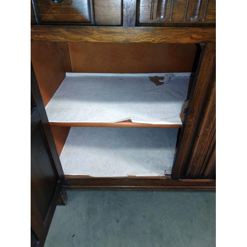 1279 - A 1950's oak buffet cupboard. 124cm x 48cm x 123cm.  COLLECT ONLY.