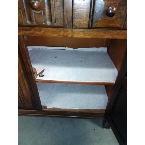 1279 - A 1950's oak buffet cupboard. 124cm x 48cm x 123cm.  COLLECT ONLY.