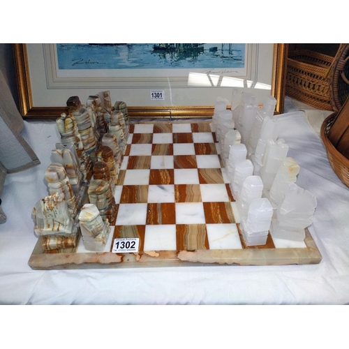 1302 - A polished stone chess set.  COLLECT ONLY.