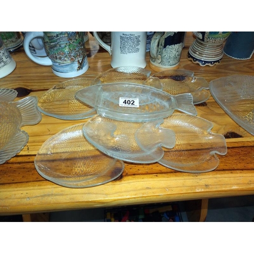 402 - A quantity of glass fish shape plates including one plastic. COLLECT ONLY.