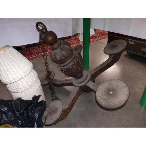 411 - Two, Five arm brass chandeliers with shades and a carved wooden arm ceiling light. COLLECT ONLY.