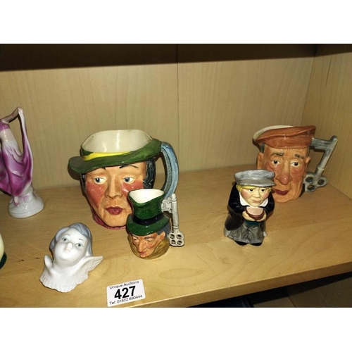 427 - A quantity of Toby jugs and figures.