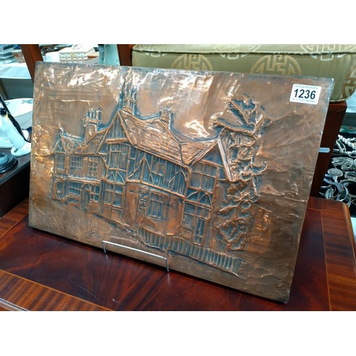 1236 - A worked Copper wall plaque of a Tudor house signed indistinct 79. 55cm x 36cm.