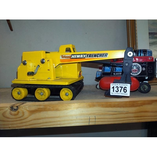 1376 - A Japanese tinplate battery operated helicopter A/F and a Triang Hi-Way trencher