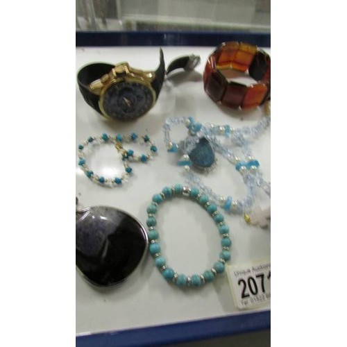 2071 - A mixed lot of stone pendants, bracelets etc and two wrist watches.