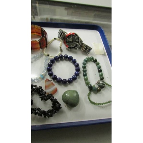 2071 - A mixed lot of stone pendants, bracelets etc and two wrist watches.