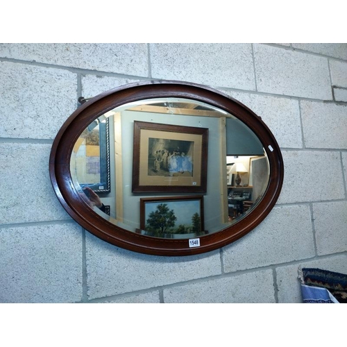 1548 - An oval framed bevelled edge wall mirror. COLLECT ONLY.