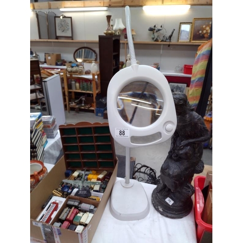 88 - A vintage illuminated magnifier on stand