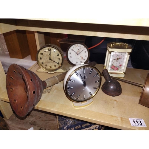 113 - A shelf on mantel clocks and copper ware.