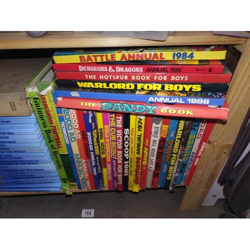 164 - A shelf of 70's 80's and 90's annuals and a set of Disney 