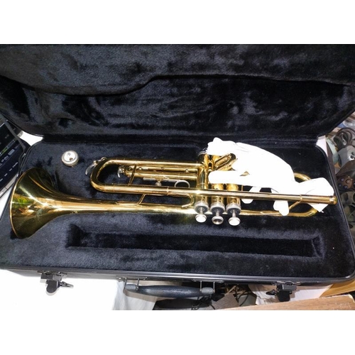 168 - A cased brass style trumpet with mouthpiece.