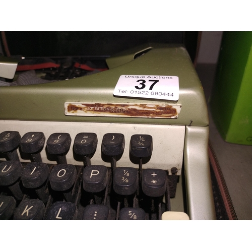 37 - A cased vintage typewriter, name badge indistinct