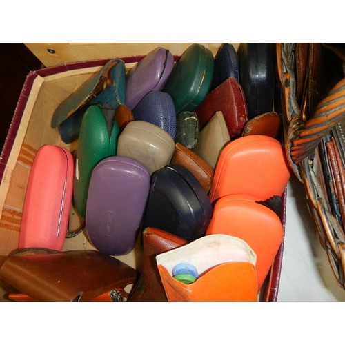 353 - A large lot of prescription glasses in cases and leather wallets.