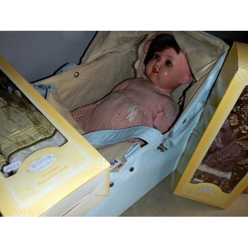 1104 - An early 20th century dolls carry cot including old doll A/F & 3 other dolls