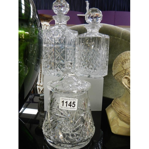 1145 - A quantity of cut glass including 2 decanters & biscuit jar.
Collect Only.