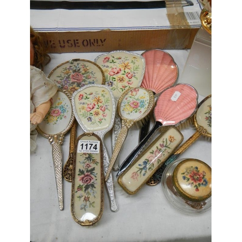 1174 - A selection of dressing table items including mirrors & brushes etc.