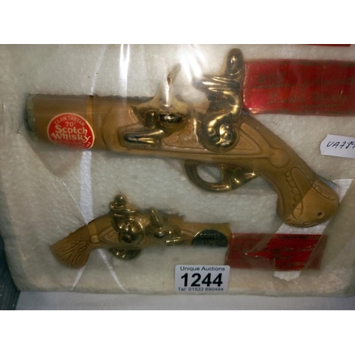 1244 - 2 pistol shaped whisky bottles