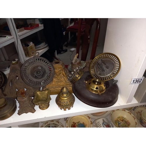 1302 - A large shelf of oil lamp parts