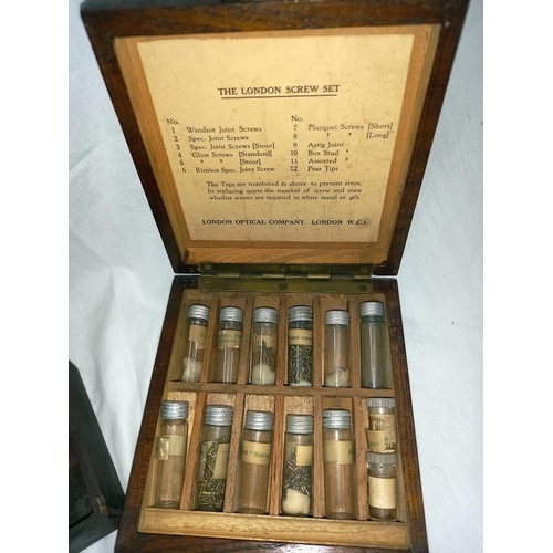 1339 - A cased London screw set with vials of miniature screws plus pan scales