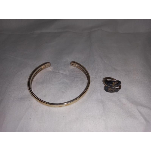 1399 - A silver bangle and silver necklaces & rings etc. Silver necklace with silver hand and simulated gem... 