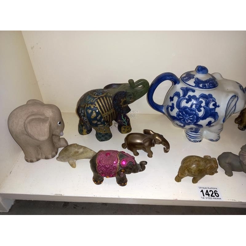 1426 - A shelf of elephants etc.