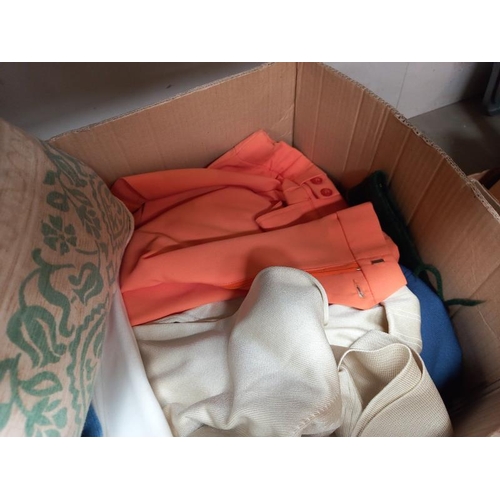 1437 - A box of blankets, cushions, cardigans etc.