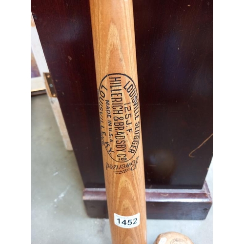 1452 - A vintage Louisville slugger & early Grady soft ball