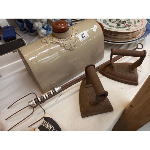 47 - A stoneware footwarmer bottle, toasting fork, fire poker and 2 irons.