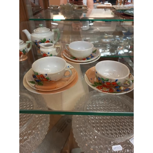 72 - A 6 piece childs/miniature tea set including teapot and sugar and milk jug ( 2 side plates missing)