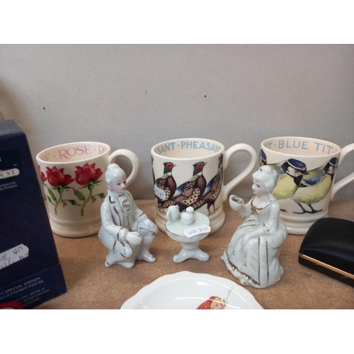 82 - A mixed lot of items including figures and mugs etc.