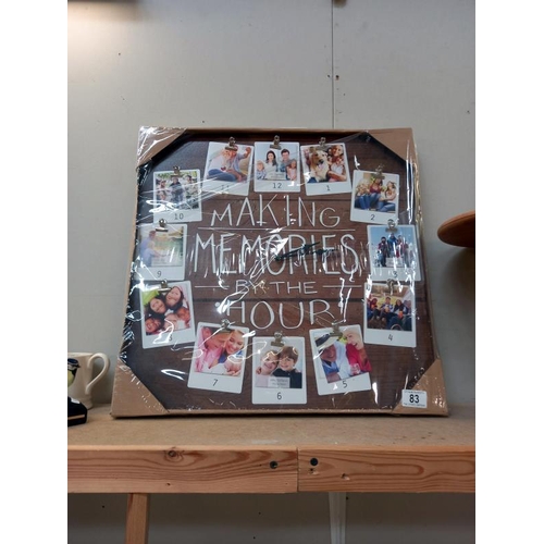 83 - A 'Making Memories by the hour' wall clock ( New in packaging 52cm square )