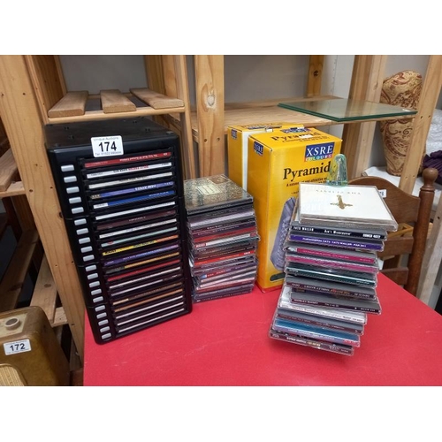 174 - Some CD's with storage drawer chest and stacking pyramids