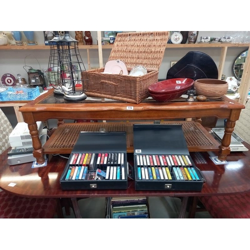 178 - A mahogany coffee table with bevel glass top and bergere panel shelf. 133 cm x 57cm x height 42cm, C... 