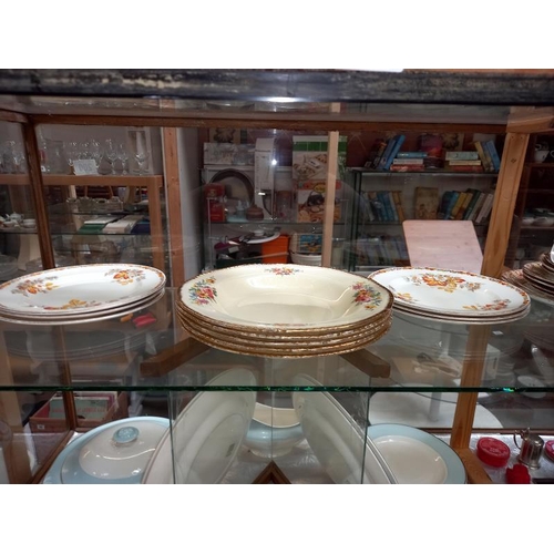 235 - A shelf of various porcelain dinner & tea ware